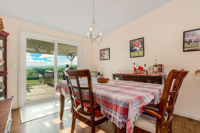 15124 NW County Road 14001st Rd, Drexel, MO 64742 - dining room featuring baseboards, wood finished floors, and a chandelier