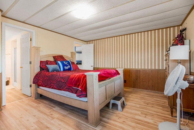 bedroom featuring a textured ceiling and light hardwood / wood-style flooring