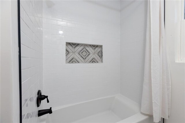 bathroom with shower / bath combo with shower curtain