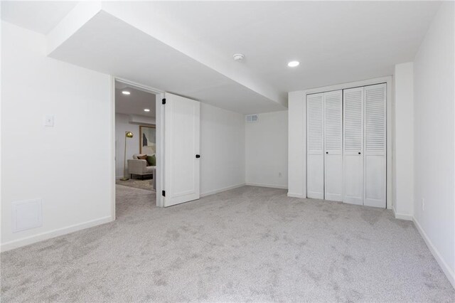 unfurnished bedroom featuring a closet and light carpet