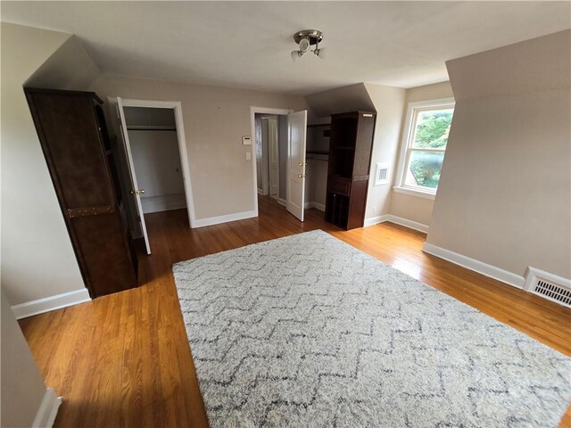 unfurnished bedroom featuring a closet and dark hardwood / wood-style flooring