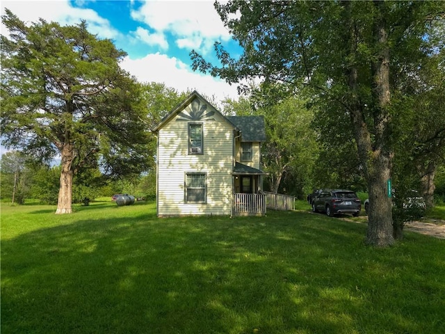 view of side of property with a yard and a porch