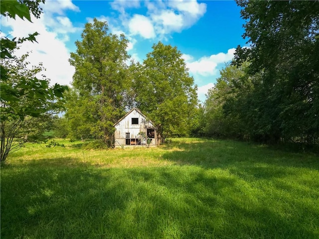 view of yard with a barn and an outbuilding