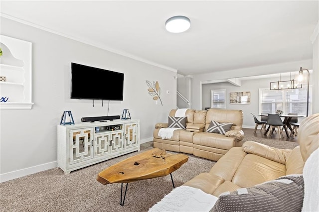 carpeted living room with ornamental molding and a chandelier