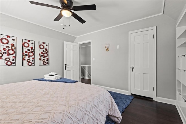 bedroom featuring crown molding, vaulted ceiling, dark wood-type flooring, and ceiling fan