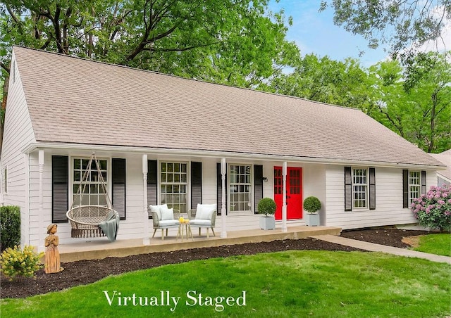 single story home with a front lawn and covered porch