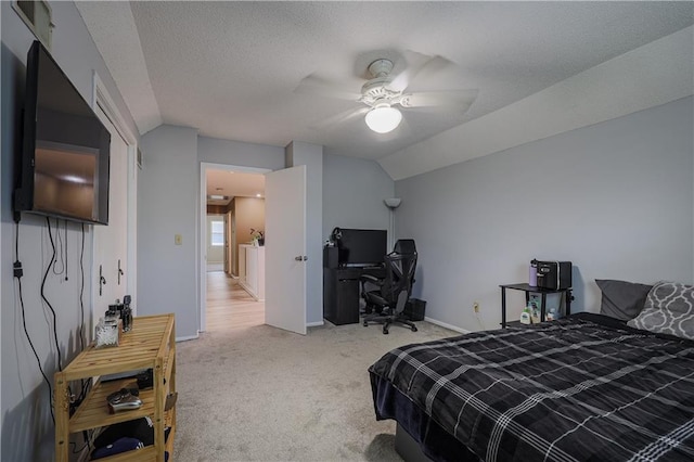 carpeted bedroom with lofted ceiling, ceiling fan, a textured ceiling, and baseboards