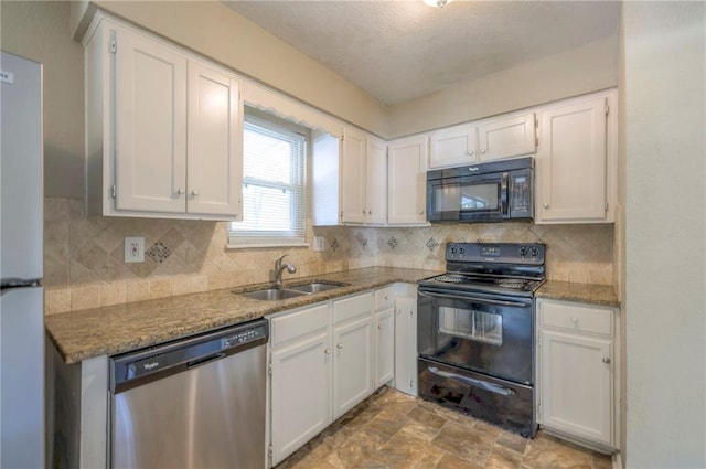 kitchen with black appliances, sink, light stone countertops, decorative backsplash, and white cabinets