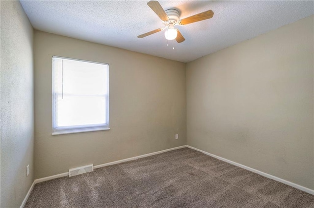 unfurnished room with a textured ceiling, ceiling fan, and carpet