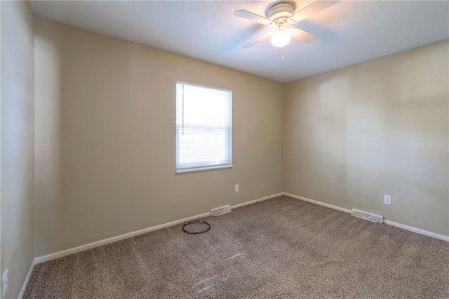 spare room with ceiling fan and carpet flooring