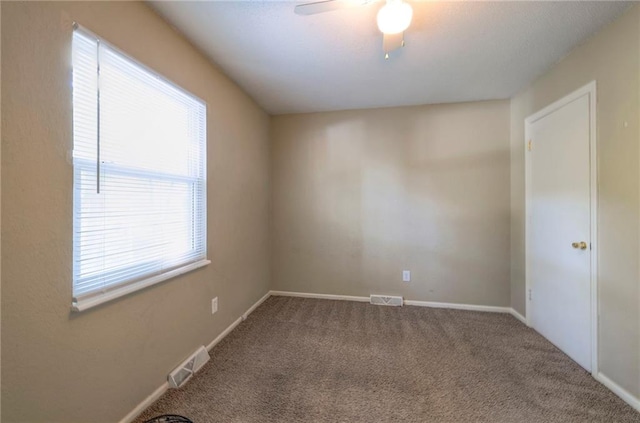 unfurnished room with ceiling fan and carpet flooring