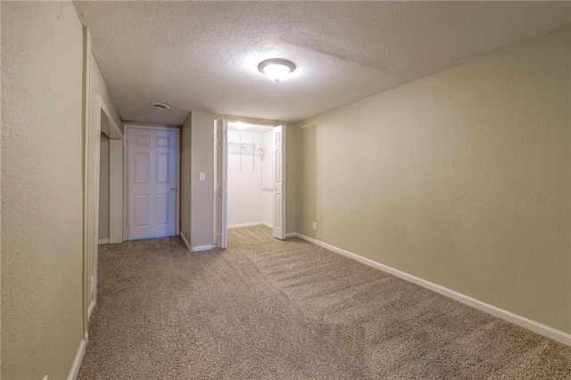 unfurnished bedroom with a closet, light colored carpet, and a textured ceiling