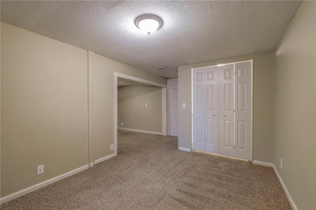 unfurnished bedroom featuring a closet, a textured ceiling, and carpet