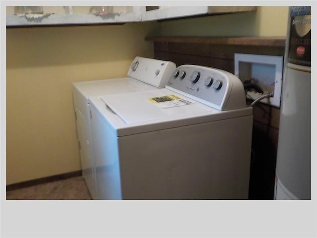 clothes washing area featuring separate washer and dryer