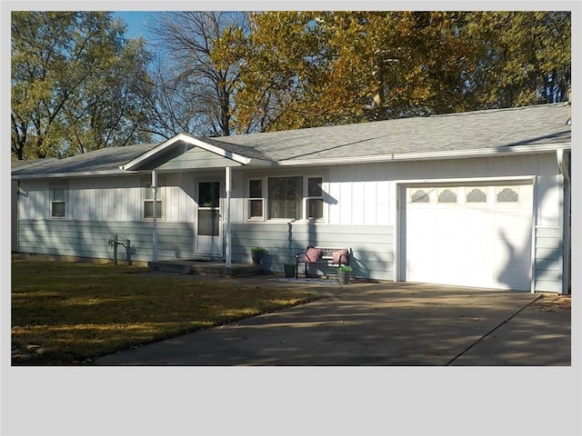 ranch-style house featuring a front yard and a garage