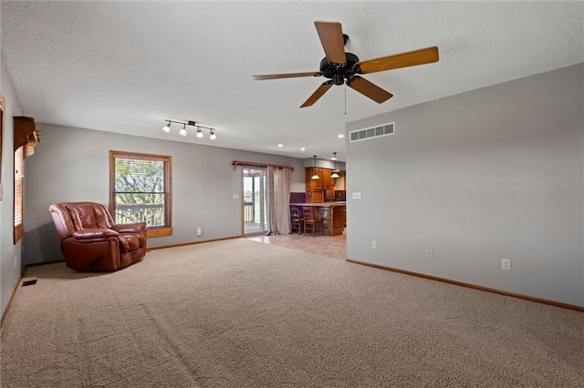 unfurnished room with ceiling fan and light carpet