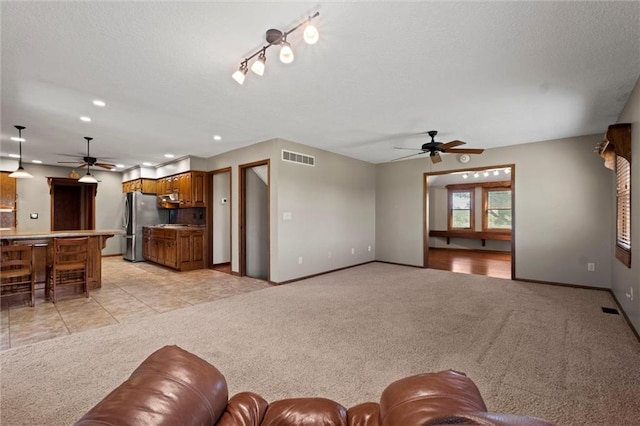 living room with light carpet and ceiling fan