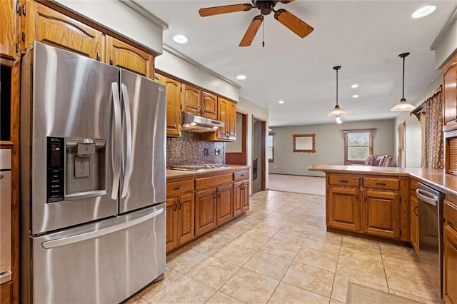 kitchen featuring light tile patterned floors, ceiling fan, appliances with stainless steel finishes, tasteful backsplash, and decorative light fixtures