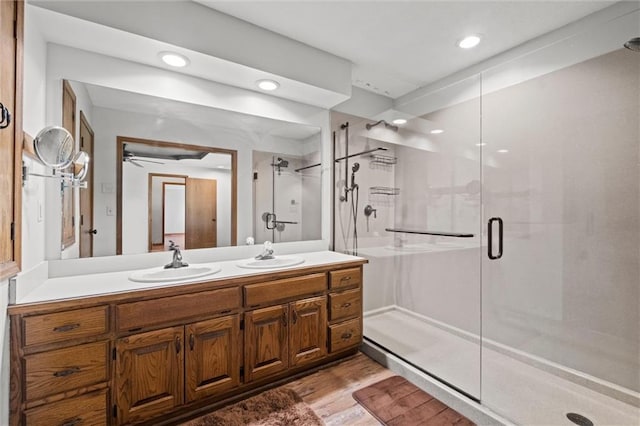 bathroom with vanity and a shower with shower door