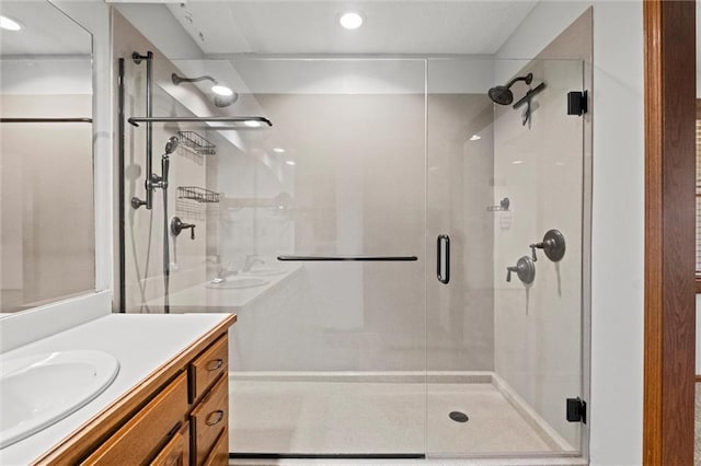 bathroom with vanity and a shower with shower door