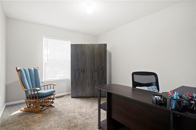 office with light carpet, a textured ceiling, visible vents, and baseboards