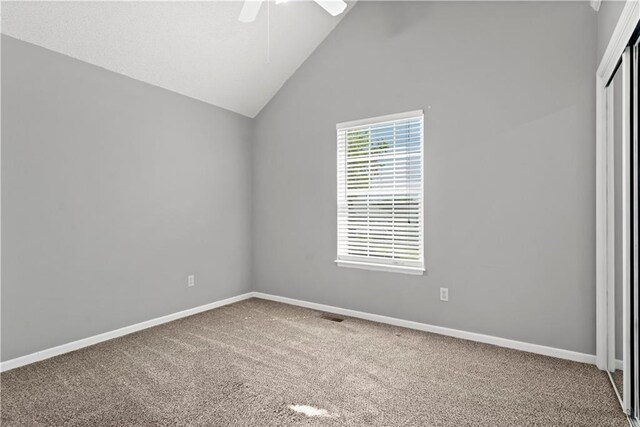 empty room with ceiling fan, carpet floors, visible vents, and baseboards