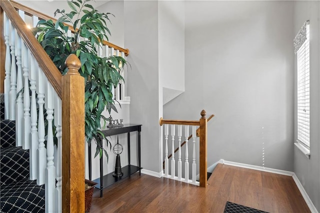 stairway featuring baseboards and wood finished floors