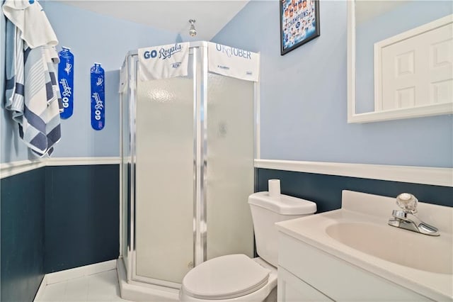 full bathroom with toilet, a stall shower, tile patterned flooring, and vanity