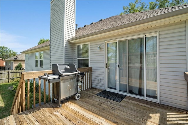 wooden terrace featuring fence and grilling area