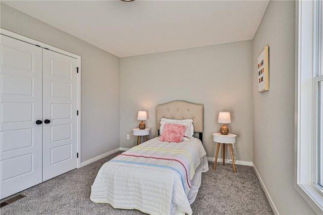 bedroom featuring a closet and light carpet