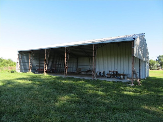 view of outbuilding featuring a yard