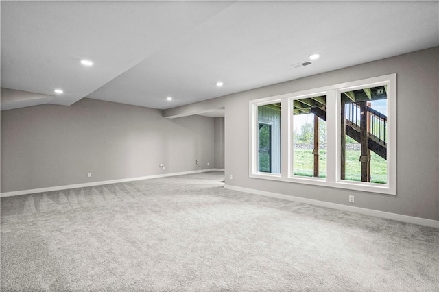 unfurnished room featuring carpet, visible vents, and baseboards