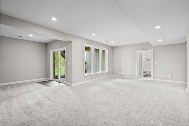 unfurnished room with baseboards, recessed lighting, visible vents, and light colored carpet