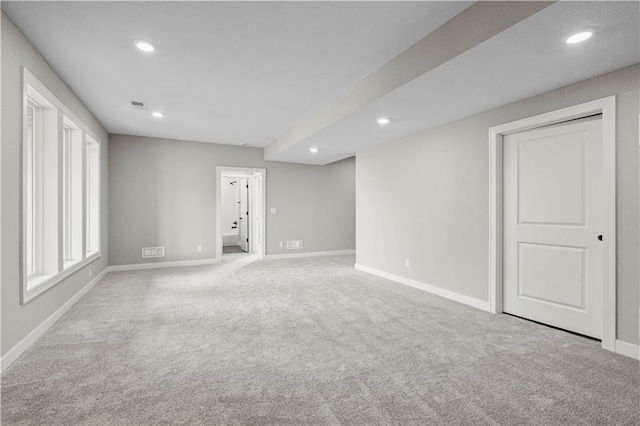 spare room featuring baseboards, recessed lighting, visible vents, and light colored carpet