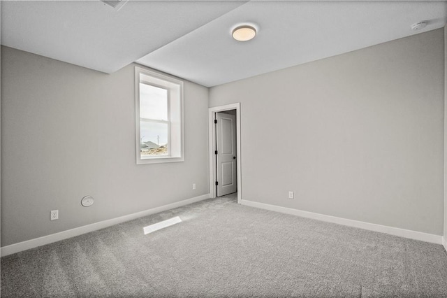 carpeted spare room with baseboards