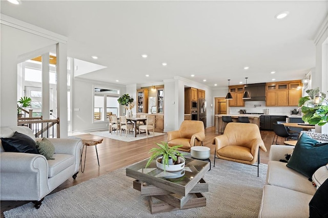 living room featuring light hardwood / wood-style floors and ornamental molding