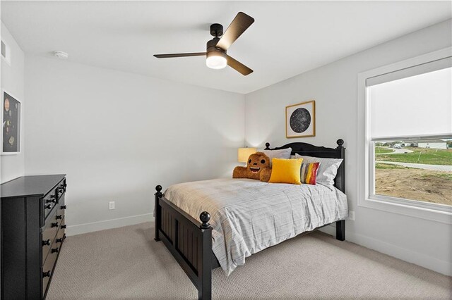 bedroom with ceiling fan and light carpet