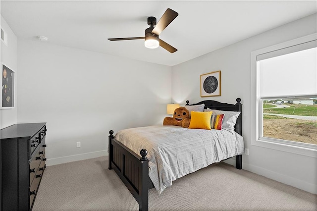 bedroom featuring light carpet and ceiling fan