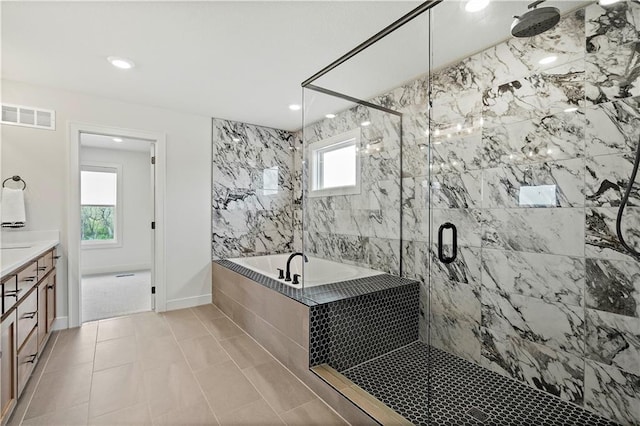 bathroom with separate shower and tub, plenty of natural light, tile patterned floors, and vanity