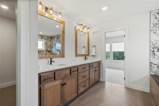 bathroom featuring tile patterned floors and dual bowl vanity