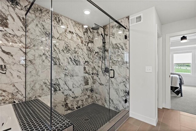 bathroom featuring an enclosed shower and tile patterned floors