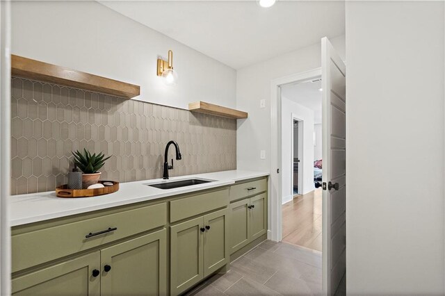 interior space with sink, tile patterned flooring, and backsplash