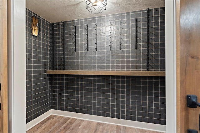 bathroom featuring hardwood / wood-style floors and a textured ceiling