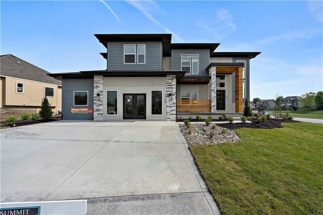 view of front facade with french doors and a front yard