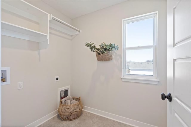 laundry area with plenty of natural light, light tile patterned flooring, electric dryer hookup, and hookup for a washing machine