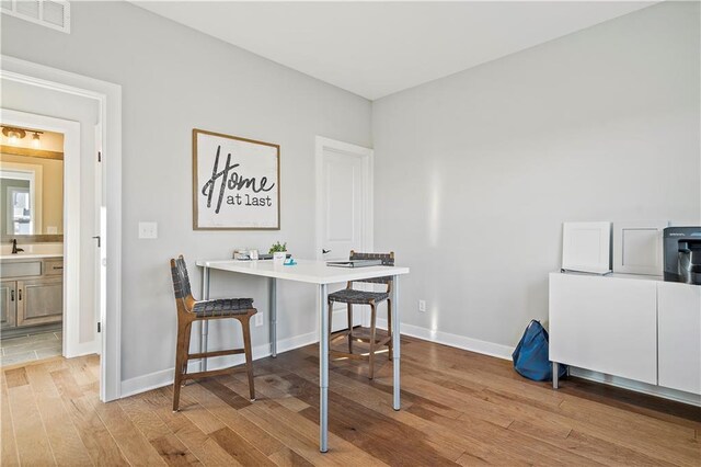 office space with sink and light hardwood / wood-style floors