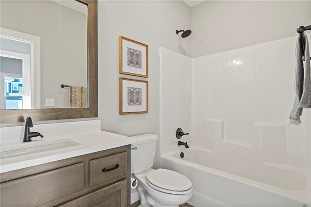 full bathroom featuring shower / bath combination, vanity, and toilet