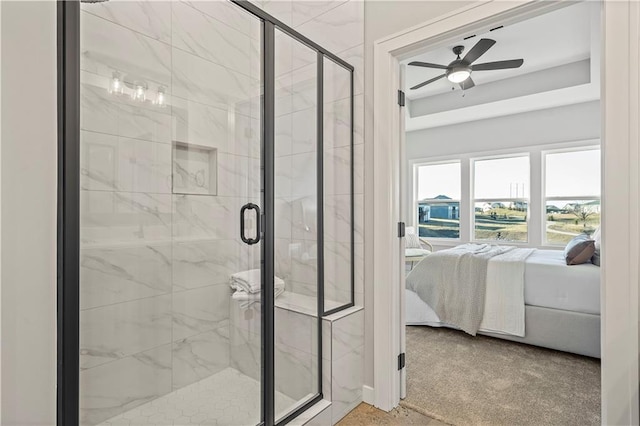 bathroom featuring ceiling fan and a shower with door