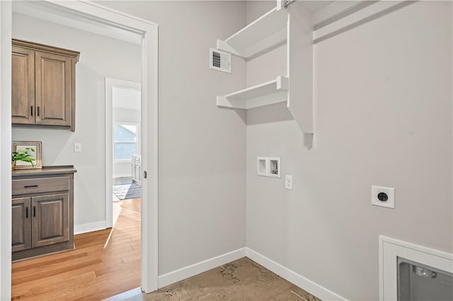 clothes washing area with hookup for an electric dryer, light wood-type flooring, and hookup for a washing machine