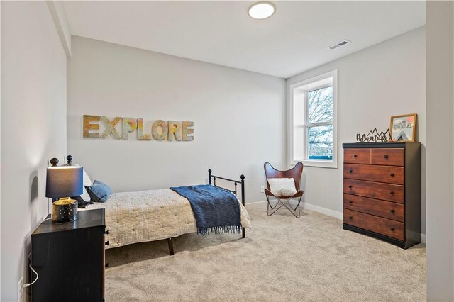 bedroom featuring light carpet